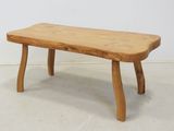 a small wooden bench that is sitting on the floor