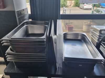several trays of food sit on a table in front of a window