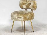 an image of a chair made of sheepskin with gold legs