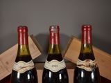 three bottles of wine sitting on a table next to each other