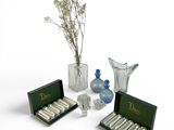 a lot of glass vases and bottles with flowers in them