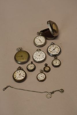 many different types of pocket watches on the table