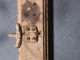 a close up of a door handle on an old suitcase
