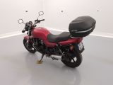 a red motorcycle that is parked in a white room