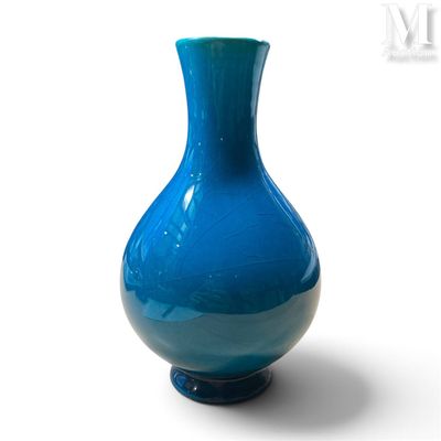 a blue vase that is sitting on a white surface