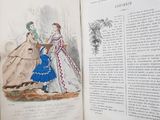 an open book with a drawing of a woman in a blue dress and another woman in a white dress