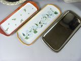 three trays that have flowers on them on a table