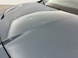 a close up of a car ' s hood with a lot of scratches