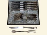 a tray with silverware and a knife and fork in it