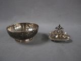 silver plated bowl and a silver plated bowl on a gray surface