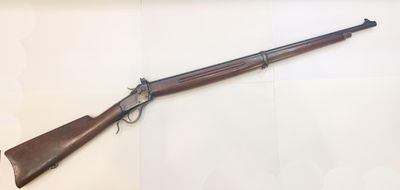 a rifle that is on display in a glass case
