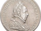une image représentant une pièce d'argent sur laquelle figure le portrait d'un homme