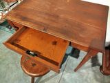 a small wooden table with a drawer underneath it