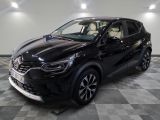 the black car is parked in a large room with checkered flooring