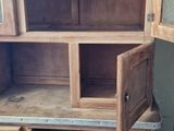 a wooden cabinet with two open doors on top of it