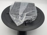 a close up of a plastic bag sitting on top of a black plate