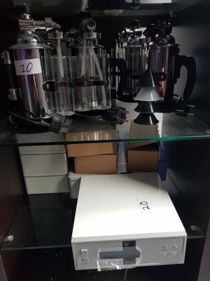 a white box sitting on top of a glass shelf in a cabinet