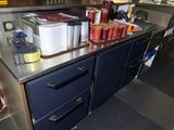 stainless steel counter top in a commercial kitchen with a variety of food items on it