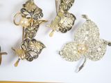 three pieces of jewelry sitting on a white surface
