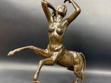 bronze statue of a woman on a horse on a base