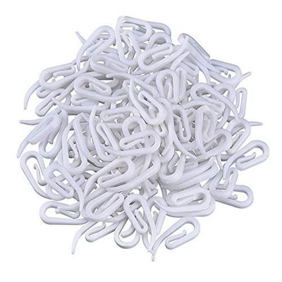 a pile of white plastic clamps on a white surface