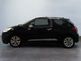 the small black car is parked on the concrete floor in the room