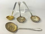 three silver spoons and a bowl are sitting on a table