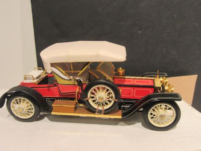 a small model of a red car on a table