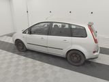 a small white car that is parked in a garage