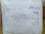 the pillow is wrapped in plastic and sitting on the floor