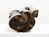 a close up of a wooden object on a white surface