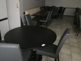 tables and chairs in a restaurant with a black table and black chairs