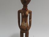 an old wooden statue of a man with a hat on his head
