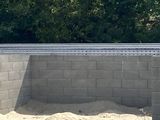 a concrete bench sitting in the middle of a dirt field
