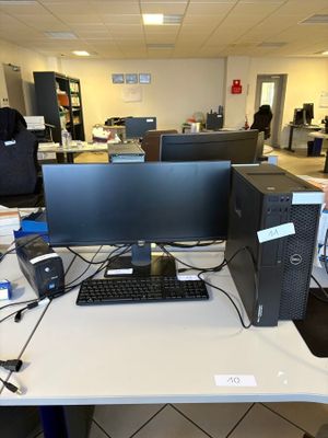a desk with a computer monitor and a keyboard on it
