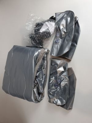 three bags of luggage sitting on top of a white wall