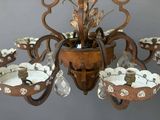a chandelier that has a bunch of flowers in it