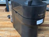 an image of a coffee maker sitting on a wooden table