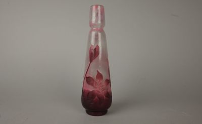 a glass vase with a pink flower inside of it