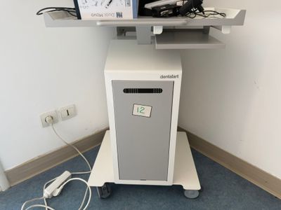 a laptop computer sitting on top of a stand