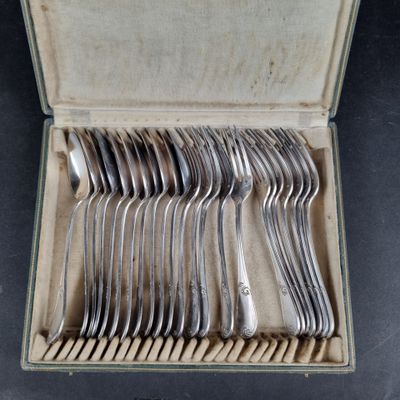 a lot of silver spoons in a box on the table