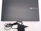 a laptop with a charger attached to it on a table