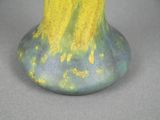 a yellow and blue vase sitting on a table