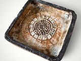 an image of a small square dish with a decorative design on it