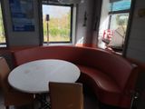a table and chairs in the corner of a restaurant