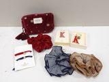 an assortment of items including a red purse, a red purse, a blue purse, and a red bow