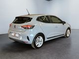 the rear view of a silver car in a showroom
