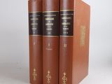 three books are sitting on a white surface, one is brown and the other is black
