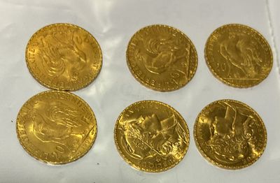 six gold sovereigns of different sizes and shapes