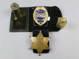 a police badge on a black case with a gold star on it